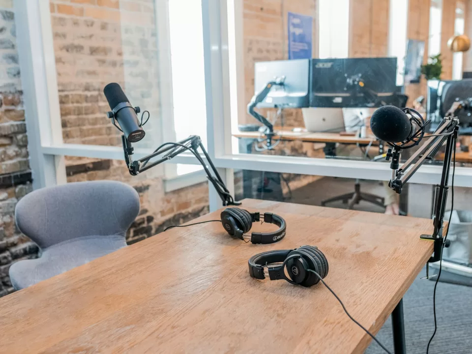Desk set up with a microphone and laptop for recording content