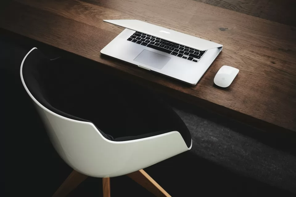 Laptop open on a clean desk in a bright room