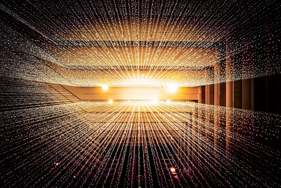 Streaks of blue and white light in a tunnel suggesting data moving at speed