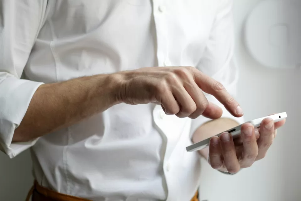 Hand holding a smartphone showing a mobile shopping screen