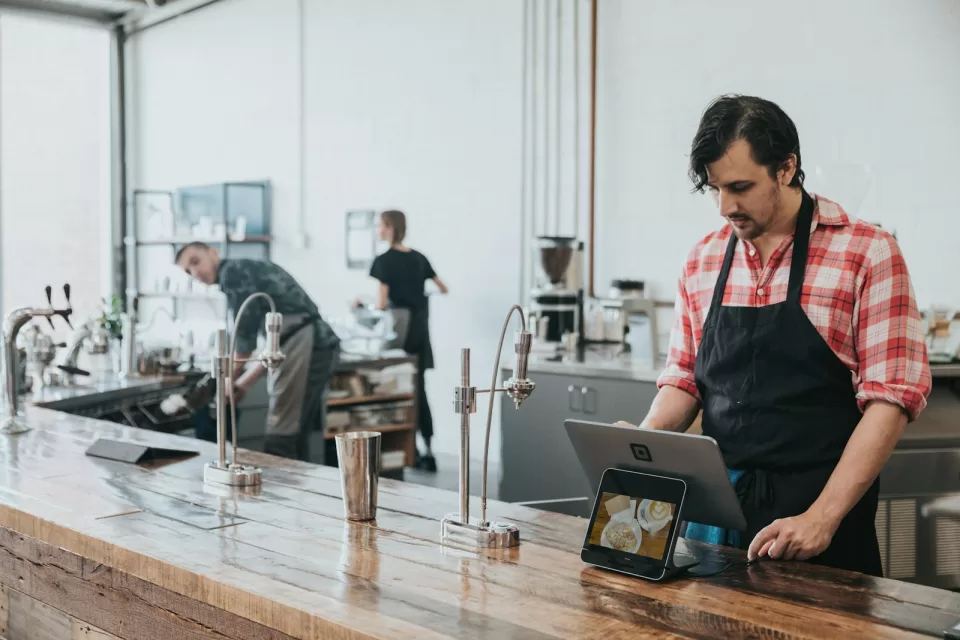 Small business owner standing behind the counter of her shop
