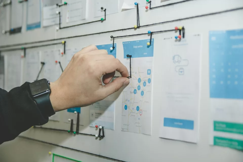 Whiteboard covered with website wireframe sketches
