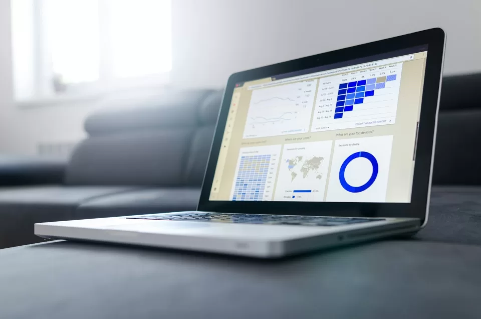 Laptop on a desk showing website analytics charts