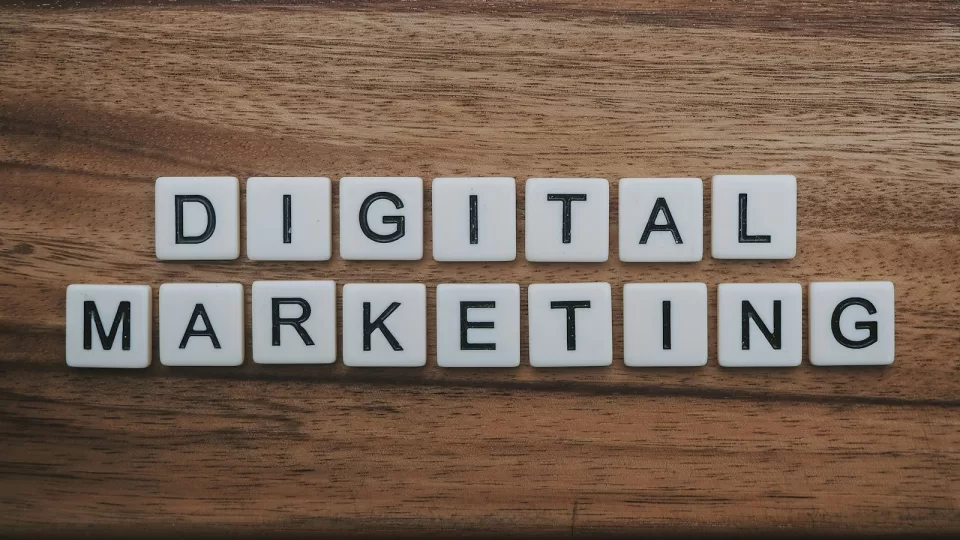 Wooden letter tiles spelling digital marketing on a table