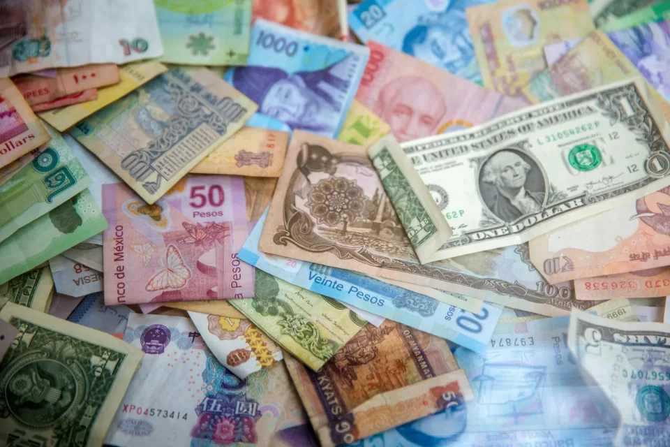 Banknotes from several countries spread out on a table