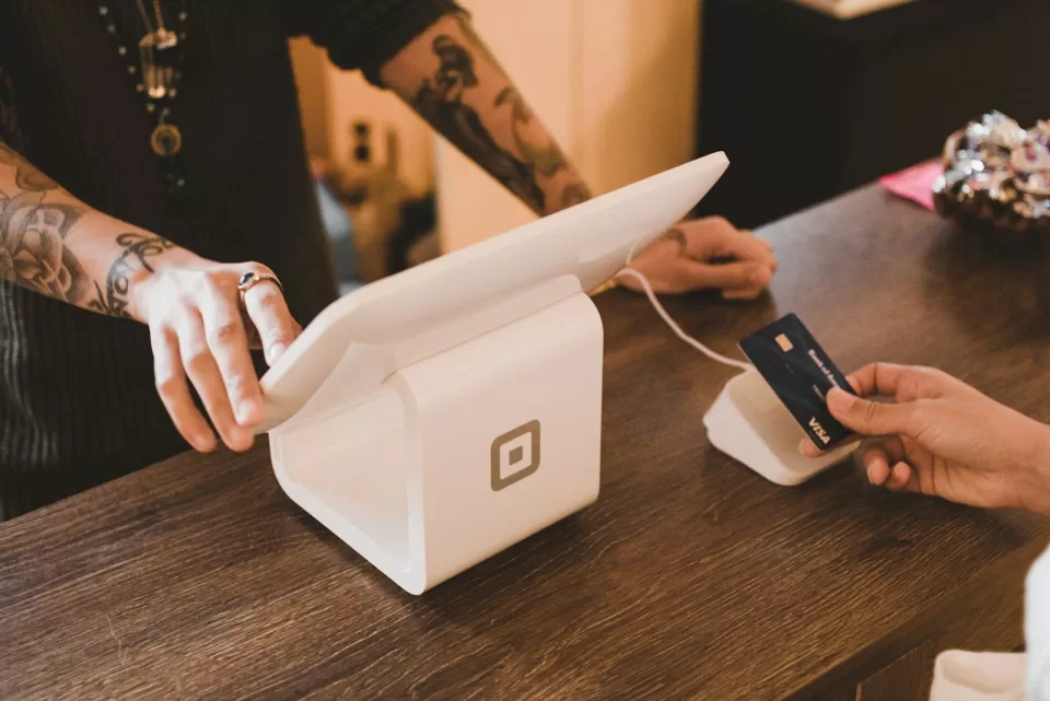 Customer tapping a contactless card on a payment terminal