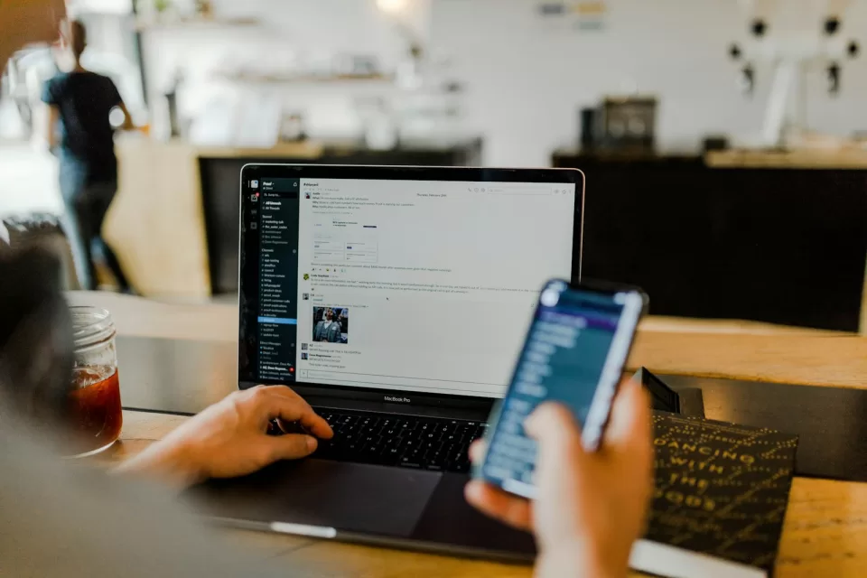 Laptop and smartphone on a desk showing online shopping pages