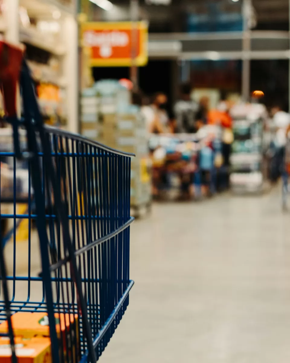 Empty shopping trolley in a blurred store aisle