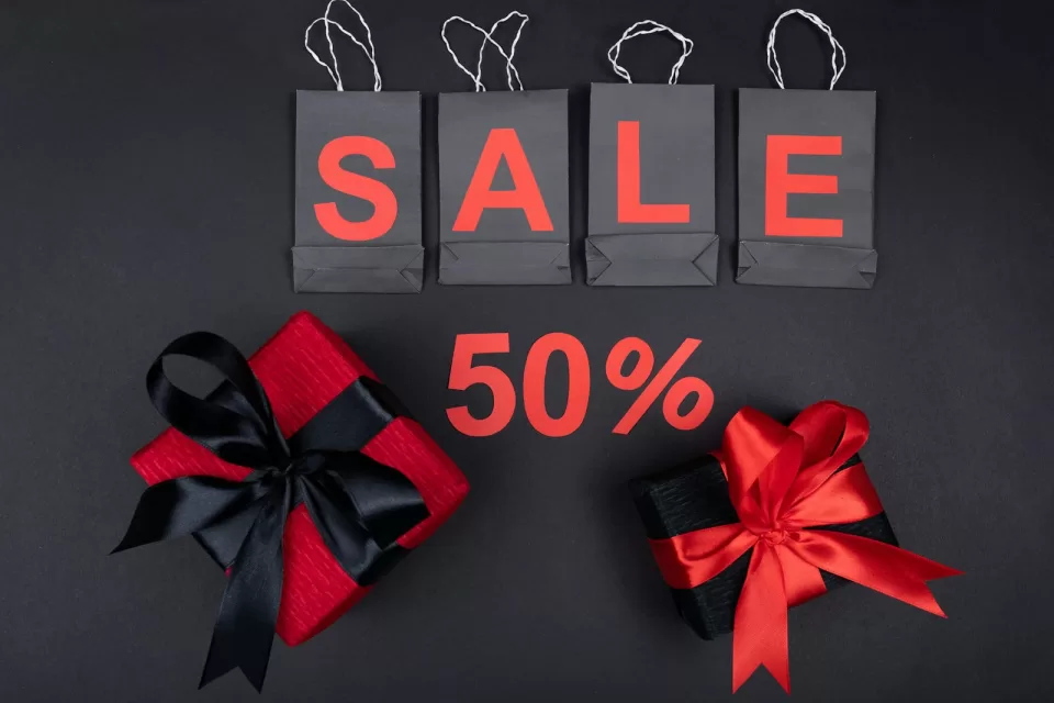 Shopping bags with sale tags against a bright background