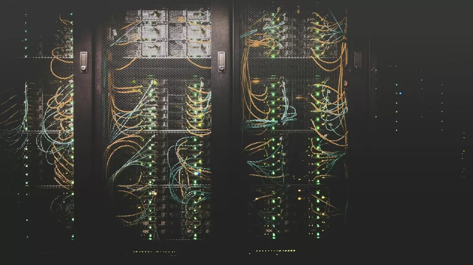 Rows of servers with blue lights in a data centre