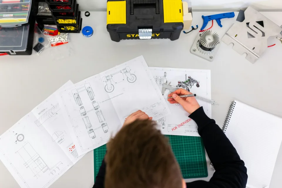 Designer sketching page layouts at a desk