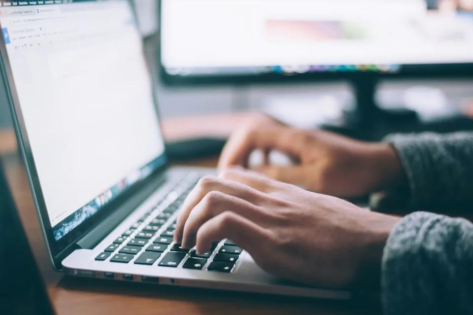Developer typing on a laptop