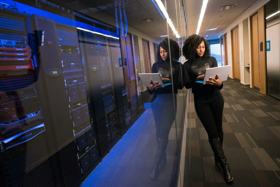 Engineer with a tablet in a server room