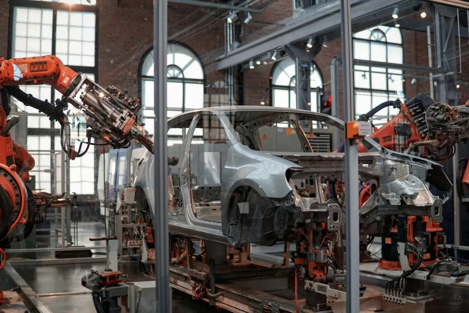 Robotic arms assembling a car in a factory