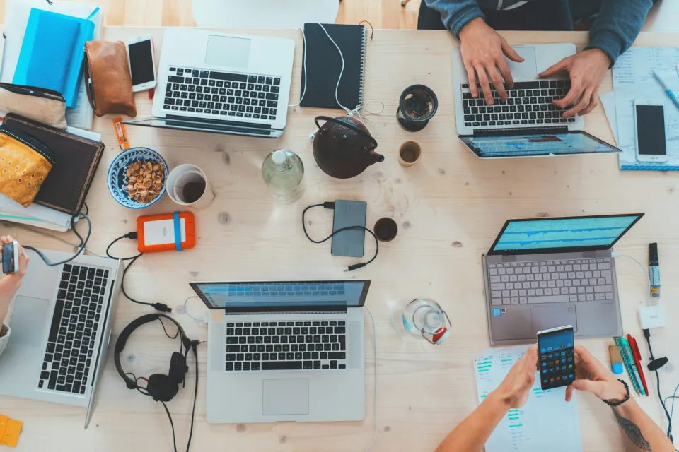 Team working together on laptops around one table